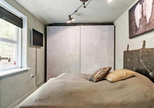 a bedroom with a bed with two pillows on it at Aarhus - cozy house, 10 min from city center in Aarhus