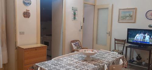 a living room with a table and a television at Casa della nonna Marina in Floridia