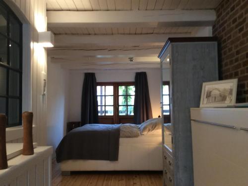 1 dormitorio con cama y espejo en Alter Fischerspeicher, en Eckernförde