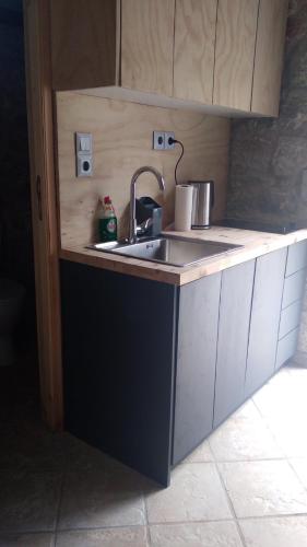 a kitchen with a sink and a counter top at Shiro - traditional stone villa in Agriliá