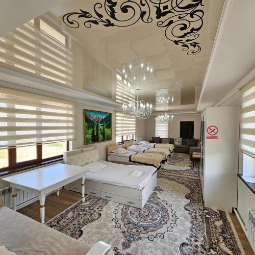 a large living room with couches and a chandelier at Guest House Tenir Too in Naryn