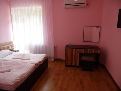 a bedroom with a bed and a table with a mirror at Hotel Restaurant Vizit in Truskavets