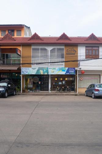 an empty parking lot in front of a building at Paknap Hostel in Nan