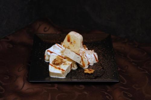 a black plate with a piece of cake on it at Hotel Garni Le Corti in Grosotto