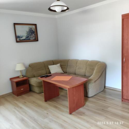 a living room with a couch and a table at Apartament pod Lipą in Kłodzko