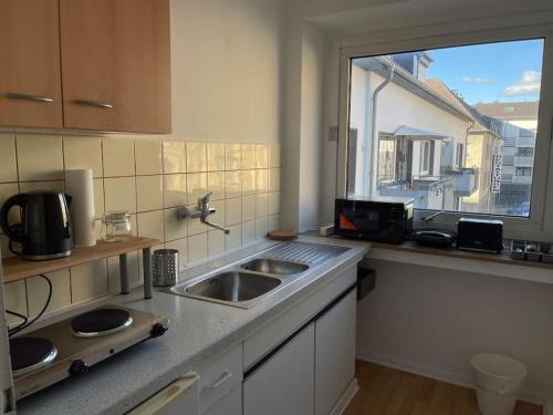 a kitchen with a sink and a window at City Appartment 2 Krefeld 20km DUS Airport/ Messe in Krefeld