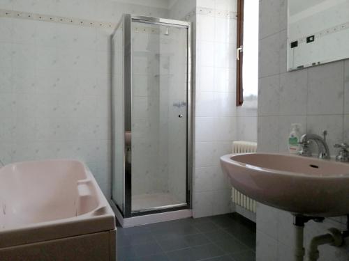 een badkamer met een glazen douche en een wastafel bij Golden Lake in Como