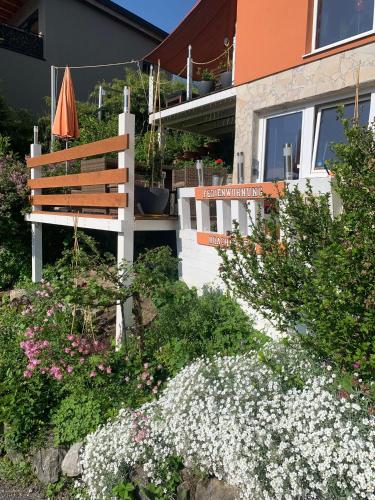 a bench and flowers in front of a building at Ferienwohnung Drachennest mit Sonnenterrasse in Feldkirch