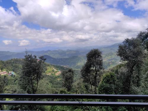 a view of a valley with mountains and trees at Stunning Views, Jujurana Homestay Shoghi ! 3 Apartments Near Simla in Shogi