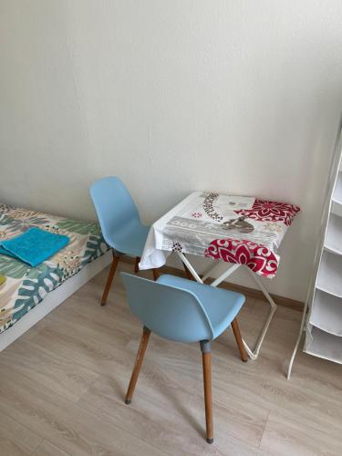 a room with a table and a chair and a bed at Your Home in Vienna