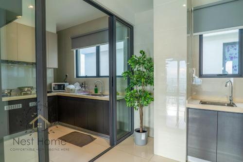 a kitchen with a glass shower and a potted plant at Country Garden Seaview Suite by Nest Home at Danga Bay in Johor Bahru