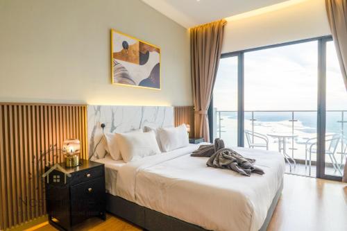 a hotel room with a bed and a balcony at Country Garden Seaview Suite by Nest Home at Danga Bay in Johor Bahru
