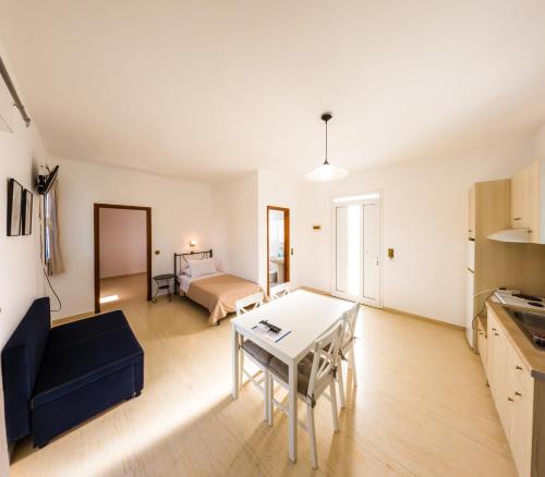 a living room with a table and a blue couch at Anna Ageliki in Damnoni
