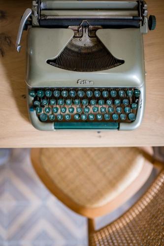 an old typewriter sitting on top of a desk at Eramai in Patra