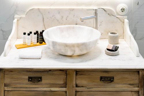 a bathroom with a large bowl sink on a counter at Eramai in Patra