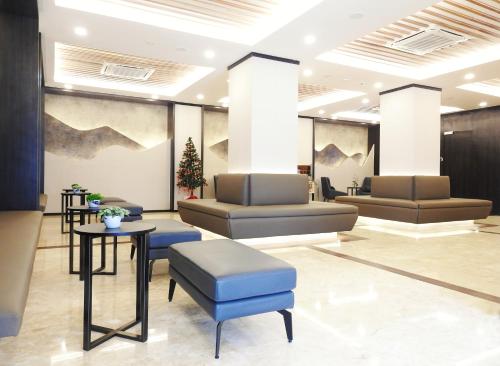 a waiting area with couches and tables in a lobby at Sky Retreat Genting Highlands in Genting Highlands