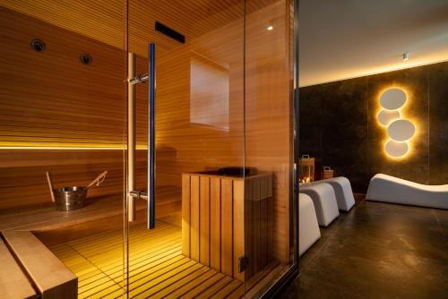 a bathroom with a sauna with two beds at Dan Hotel in Riccione