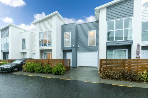 a house with a car parked in front of it at Comfy Stay Close to City Center in Hamilton