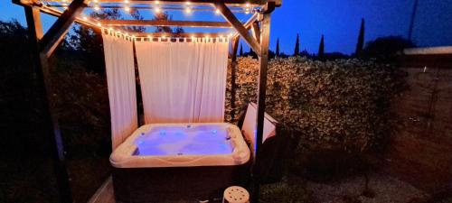a hot tub under a gazebo with lights at Holiday Home Ulika in Fažana