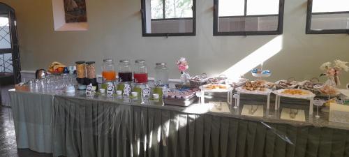 a buffet with food and drinks on a table at Hotel Maddalena in Marina di Ravenna