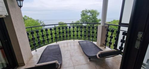 a balcony with chairs and a view of the ocean at The Cliff in Obzor