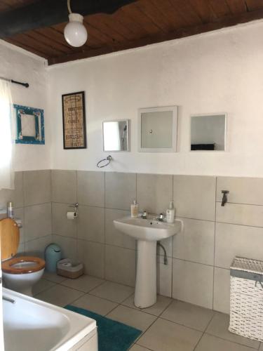a bathroom with a sink and a toilet at Villa Jullienne - A Home Away From Home - Unit 9 in Nelspruit