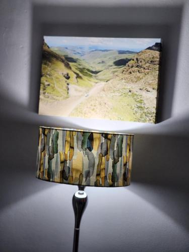 a lamp with a picture of a desert at Motebong Villa in Maseru