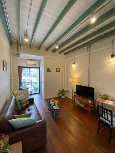 a living room with a couch and a table at 1 min walk to BTS, 3 Bed 3 Bath, Entire House in Bangkok