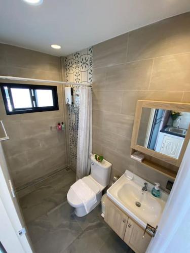 a bathroom with a toilet and a sink at 1 min walk to BTS, 3 Bed 3 Bath, Entire House in Bangkok