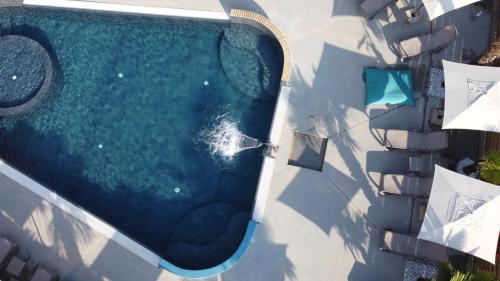 an overhead view of a swimming pool next to a building at Hotel Rudy in Riva del Garda