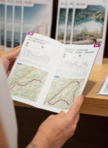 a person is holding a map in their hands at Hotel Rudy in Riva del Garda