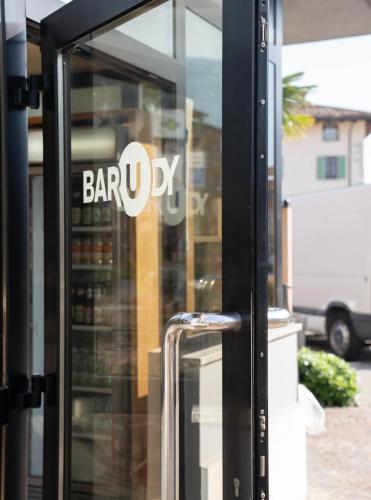 a glass door with a bar ux sign on it at Hotel Rudy in Riva del Garda