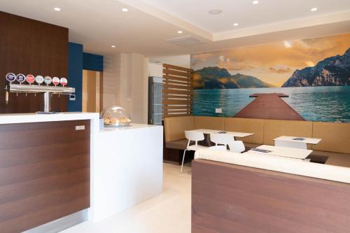 a restaurant with a painting of a boat on the wall at Hotel Rudy in Riva del Garda