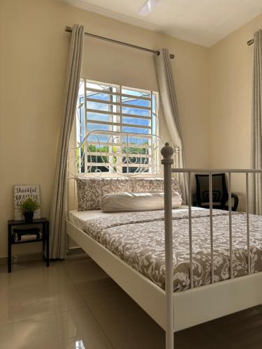 a bedroom with a bed and a window at DeAsmarra Homestay in Tanjung Piandang