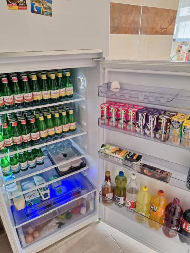 an open refrigerator filled with lots of drinks at My Home in Beysehir