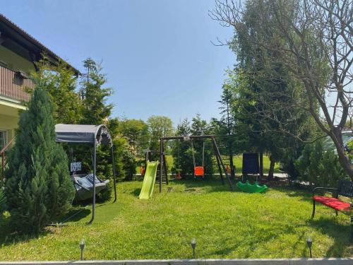 a yard with a playground with two swings at Hotel Marislav in Češnovice