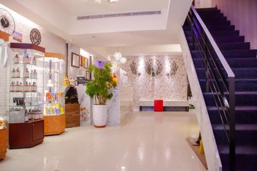 a store hallway with a staircase and a stair case at E-Coast Star Hotel in Keelung