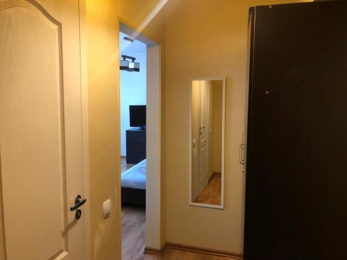 an open door to a room with a bedroom at Apartamenti Elkonju 3 in Liepāja