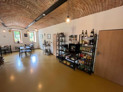 a large room with a store with bottles of wine at Apart Pension Zelený grunt in Dřínov