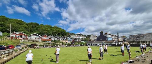 a group of people standing on a field at Sea Cliff View Designer Home in Lyme Regis