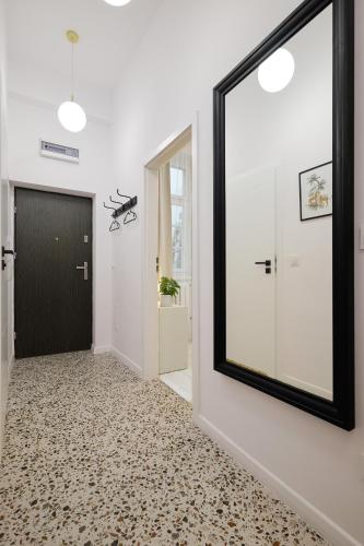 a hallway with a black door and a mirror at Plac Ratuszowy 50 - Old Town - 2 Sypialnie i Salon in Jelenia Góra