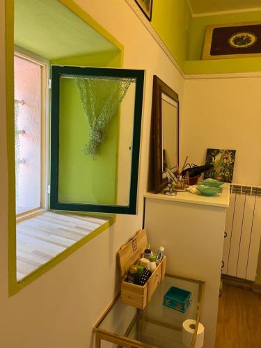 a room with a mirror and a glass table at Maremma Toscana Podere Poggiarelli in Campagnatico