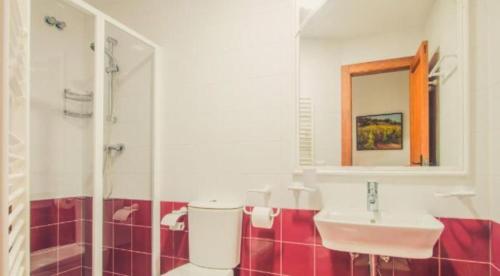 a bathroom with a sink and a toilet and a mirror at Villa ROCAZUL in Jávea
