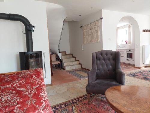 a living room with a chair and a fireplace at Romantisches Ferienhaus in Moselnähe in Maring-Noviand