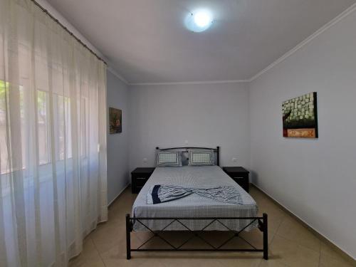 a bedroom with a bed in the corner of a room at Vila Duro in Ksamil