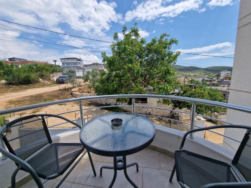 a table and chairs on a balcony with a view at Vila Duro in Ksamil