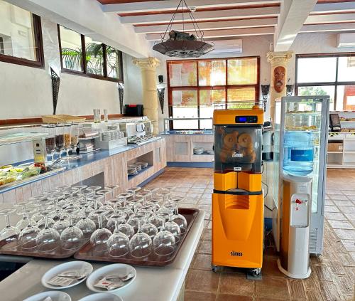 a kitchen with a drink machine in the middle at Dulce Nombre Hotel - Apartamentos in Tarifa