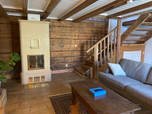a living room with a couch and a staircase at Krepelin Apartments in Kristiinankaupunki