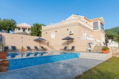 a villa with a swimming pool and a house at Villa Clearvue 