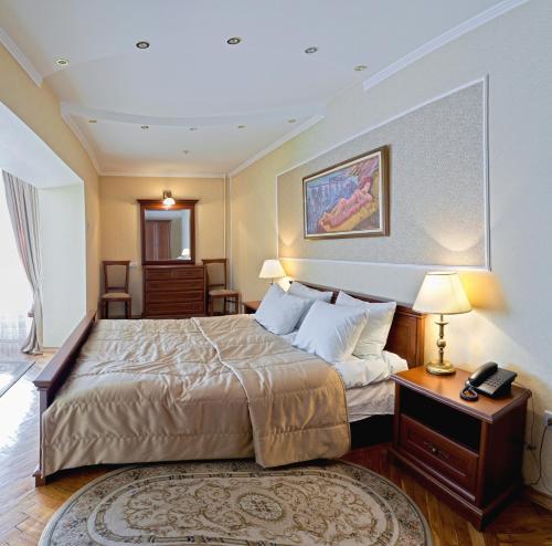 um quarto de hotel com uma cama e um telefone em Hetman Hotel em Lviv